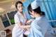 A nurse is checking a patient's blood pressure.