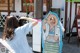 A woman taking a picture of a woman in a kimono.