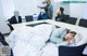 A woman sleeping on a bed in a conference room.