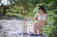 A woman in a white bikini sitting on a beach.